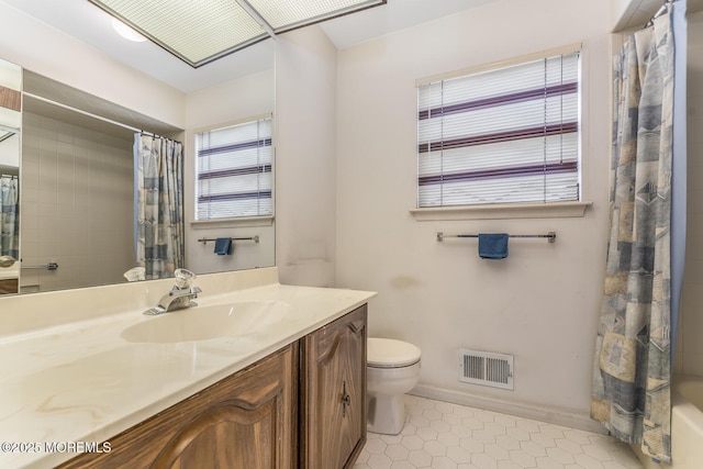 full bathroom featuring vanity, tile patterned flooring, toilet, and shower / bath combo with shower curtain