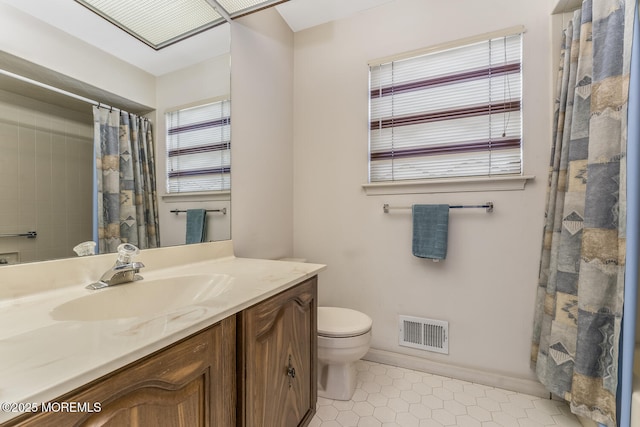 bathroom featuring a shower with shower curtain, vanity, toilet, and a wealth of natural light