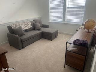 living room with light carpet and baseboards