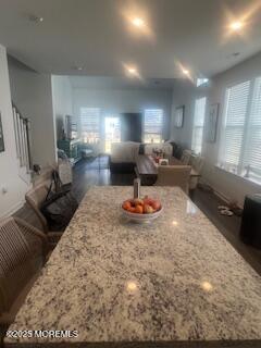 kitchen featuring light stone counters, a center island, and open floor plan