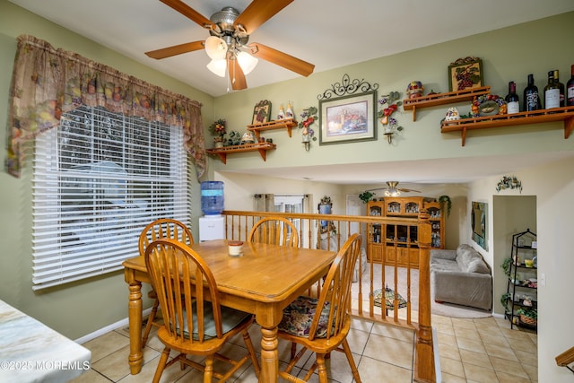 tiled dining space with a wealth of natural light and ceiling fan