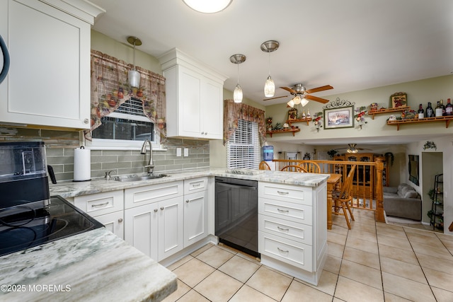 kitchen with white cabinets, black appliances, decorative light fixtures, sink, and kitchen peninsula