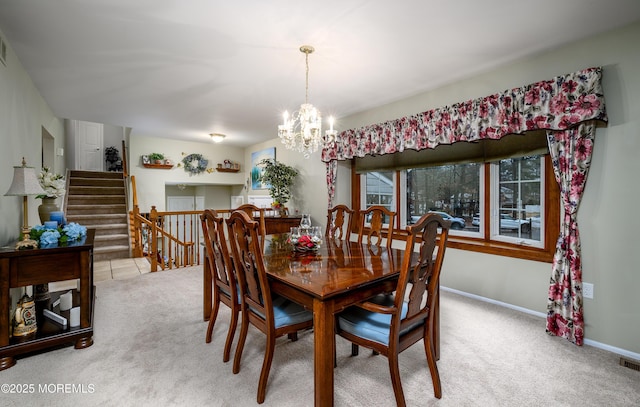 dining room featuring light carpet and a notable chandelier