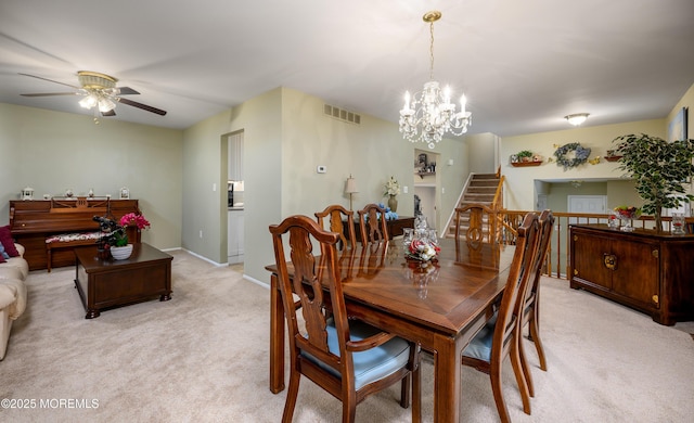 dining area with light colored carpet and ceiling fan with notable chandelier