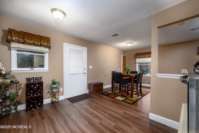 dining space with dark wood-type flooring