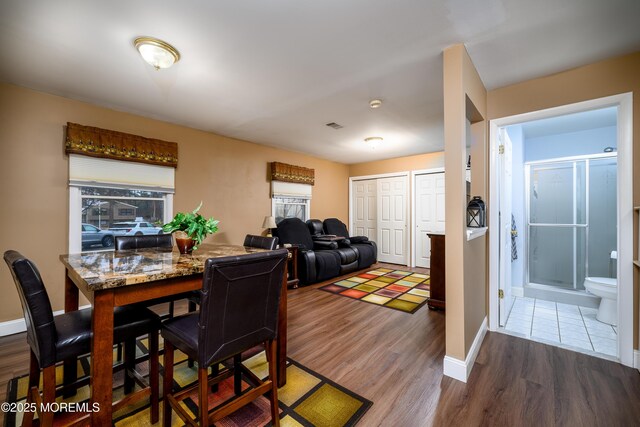 dining space with hardwood / wood-style flooring