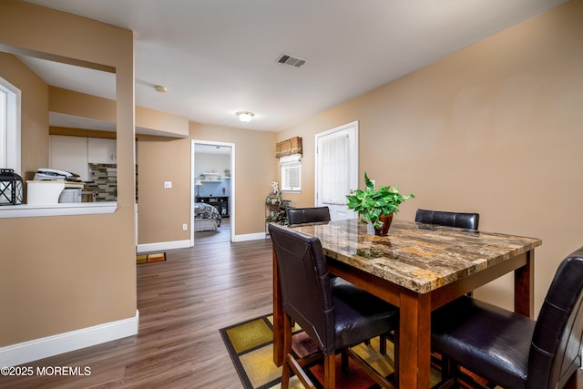 dining room with dark hardwood / wood-style floors