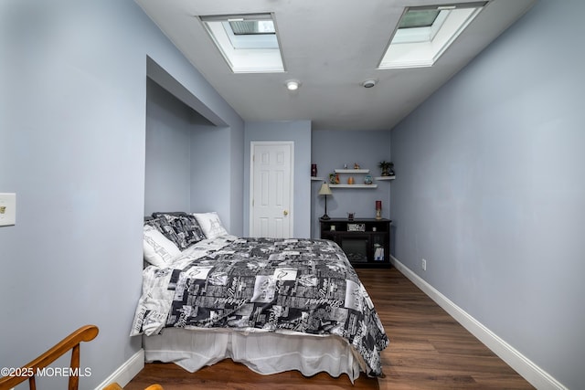 bedroom with dark wood-type flooring and a skylight