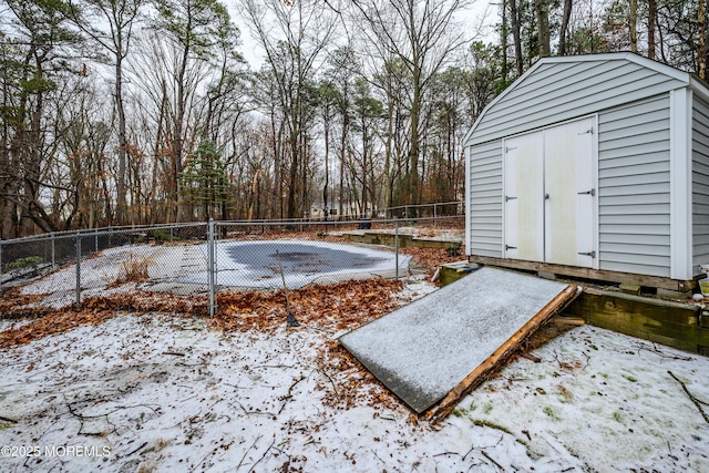 yard covered in snow with a shed