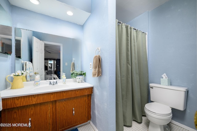 bathroom featuring a shower with shower curtain, tile patterned flooring, vanity, and toilet