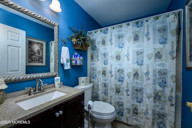 bathroom featuring vanity, toilet, and walk in shower