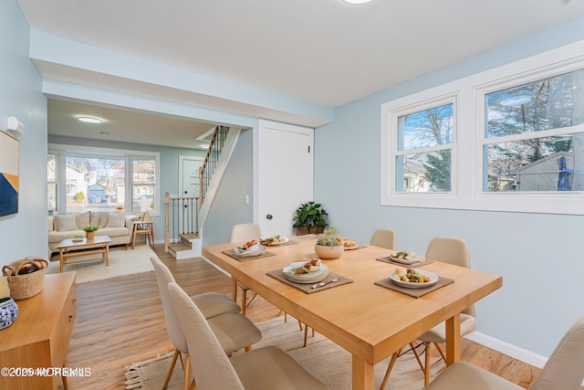 dining space with light hardwood / wood-style flooring