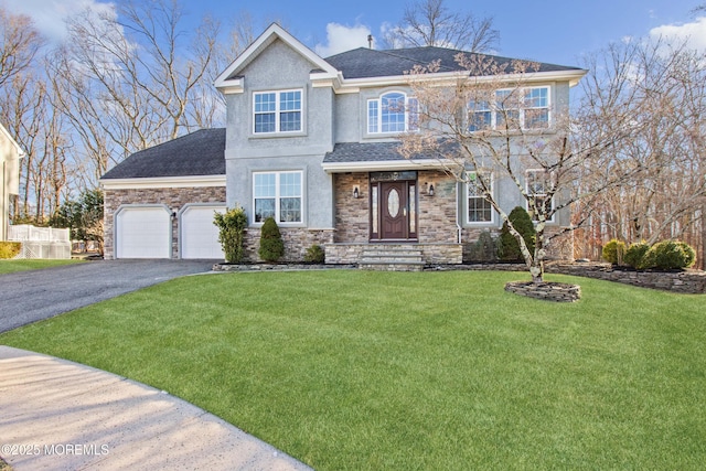 view of front of property with a front yard and a garage