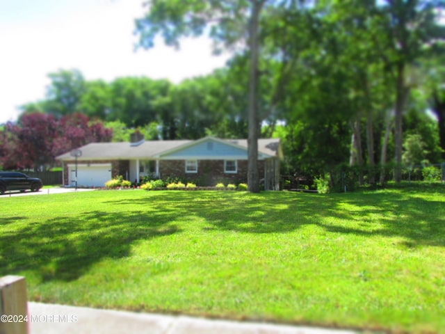 view of front of home with a garage and a front lawn