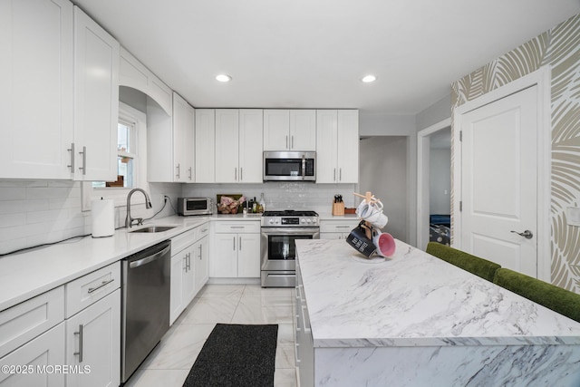 67 Grand Ave, Toms River, NJ 08753 - kitchen featuring stainless steel appliances, a sink, and white cabinets