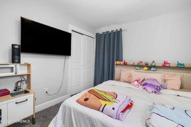 67 Grand Ave, Toms River, NJ 08753 - bedroom with a closet, dark carpet, and baseboards