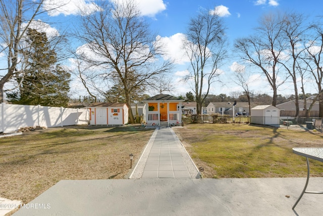 view of front of home featuring a storage unit and a front lawn