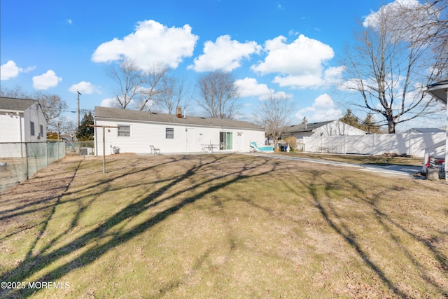 rear view of house with a lawn