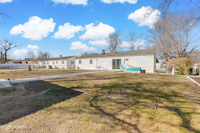 back of house featuring a patio area and a yard