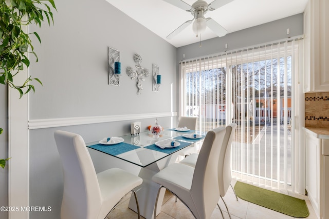 dining area with light tile patterned floors and ceiling fan