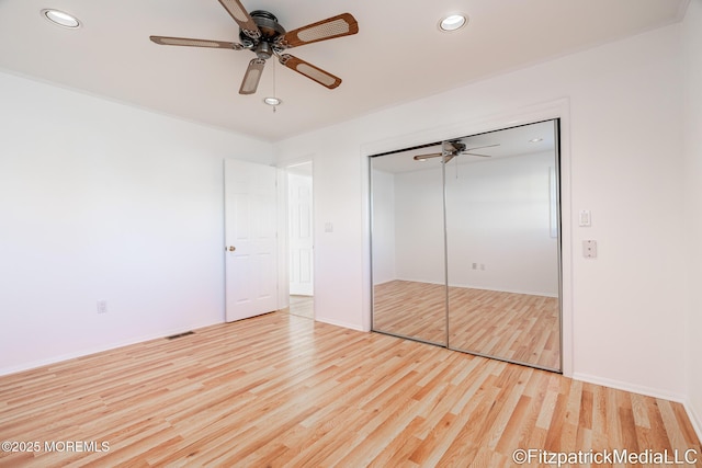 unfurnished bedroom featuring a closet, ceiling fan, and light hardwood / wood-style flooring