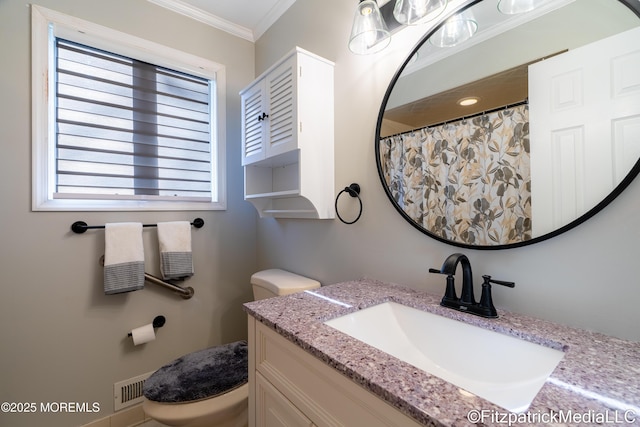 bathroom featuring vanity, crown molding, and toilet