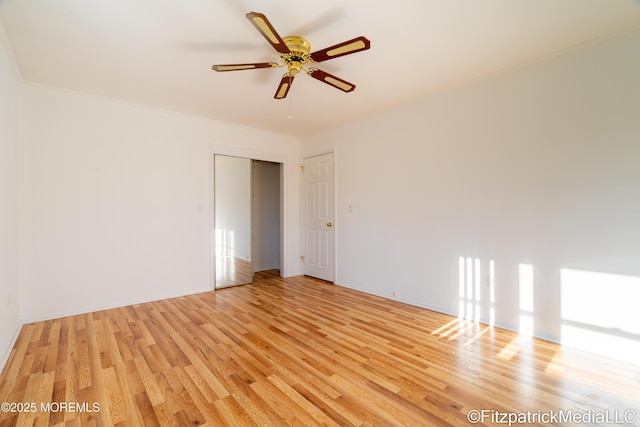 empty room with light wood-type flooring and ceiling fan