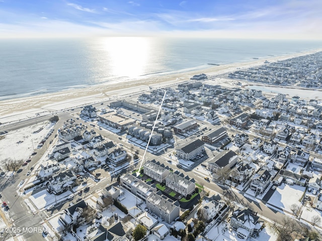 drone / aerial view featuring a water view and a beach view