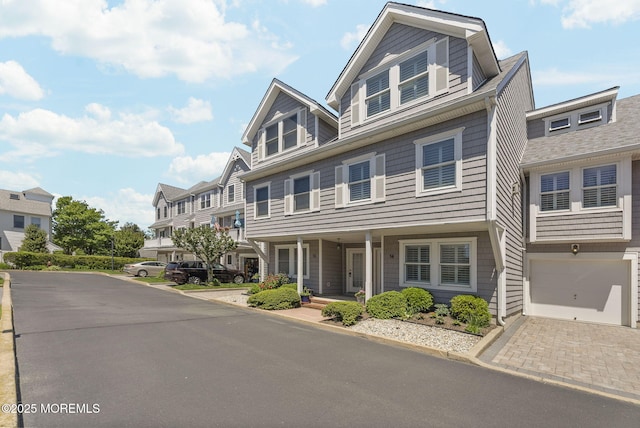 200 2nd Ave Unit 14, Belmar, NJ 07719 - view of property featuring an attached garage, a residential view, a porch, and decorative driveway