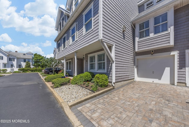 200 2nd Ave Unit 14, Belmar, NJ 07719 - view of front facade with decorative driveway, an attached garage, and a residential view