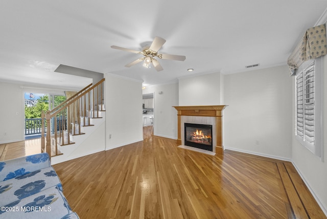 200 2nd Ave Unit 14, Belmar, NJ 07719 - unfurnished living room featuring a tiled fireplace, wood finished floors, stairway, a ceiling fan, and baseboards