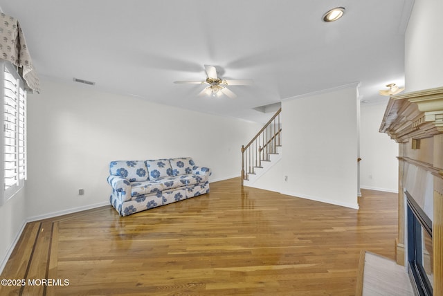 200 2nd Ave Unit 14, Belmar, NJ 07719 - unfurnished room with a fireplace with flush hearth, a ceiling fan, wood finished floors, stairs, and baseboards