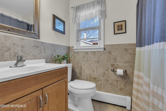 bathroom with vanity, tile walls, toilet, tile patterned floors, and a baseboard heating unit