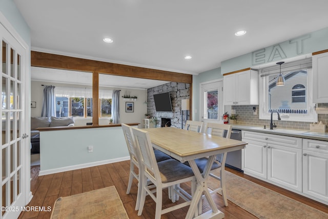 kitchen featuring light countertops, pendant lighting, open floor plan, and white cabinets