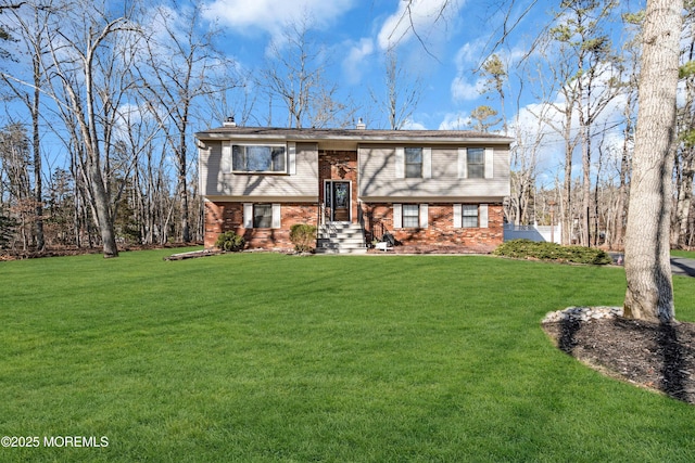 raised ranch with a front yard