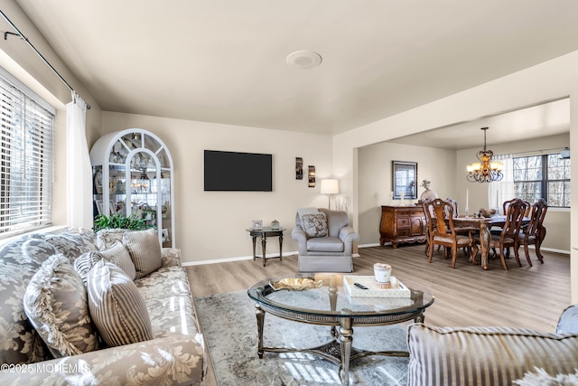 living room featuring hardwood / wood-style flooring and an inviting chandelier