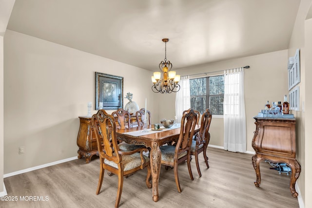 dining area featuring a notable chandelier and hardwood / wood-style floors