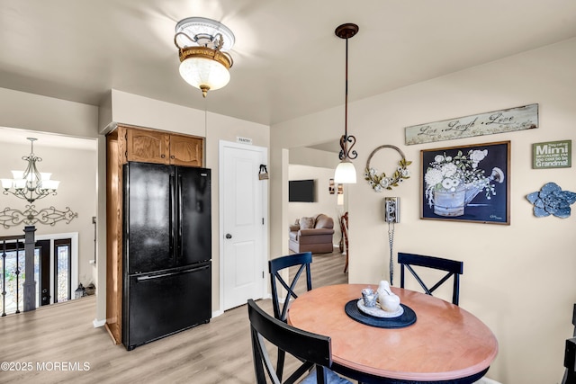 dining area featuring a chandelier and light hardwood / wood-style flooring