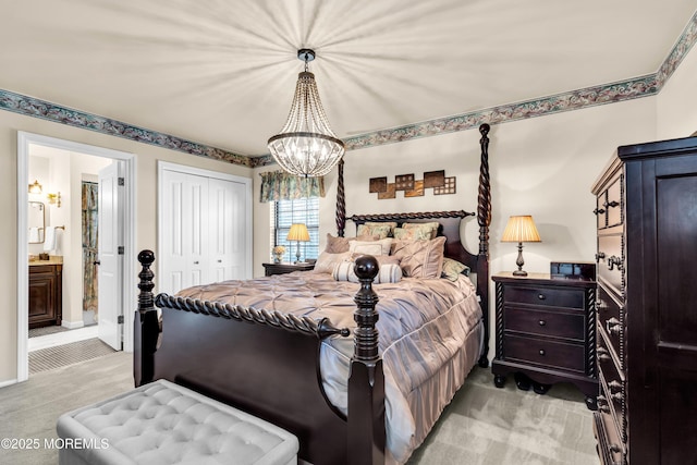 bedroom with connected bathroom, a chandelier, a closet, and light colored carpet