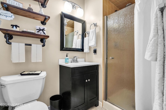 bathroom with an enclosed shower, vanity, and toilet