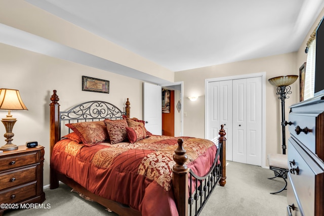 bedroom featuring a closet and light colored carpet