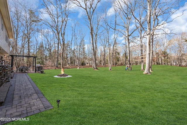 view of yard with a patio and a fire pit