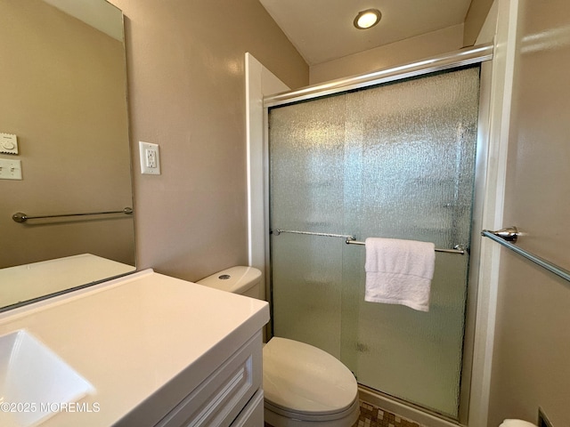 full bathroom with a shower stall, toilet, and vanity