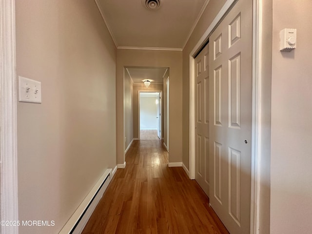 corridor with dark wood-style floors, visible vents, ornamental molding, and baseboards