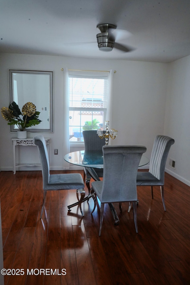 dining space with dark hardwood / wood-style flooring