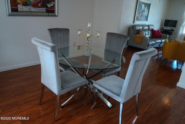 dining area with dark hardwood / wood-style flooring