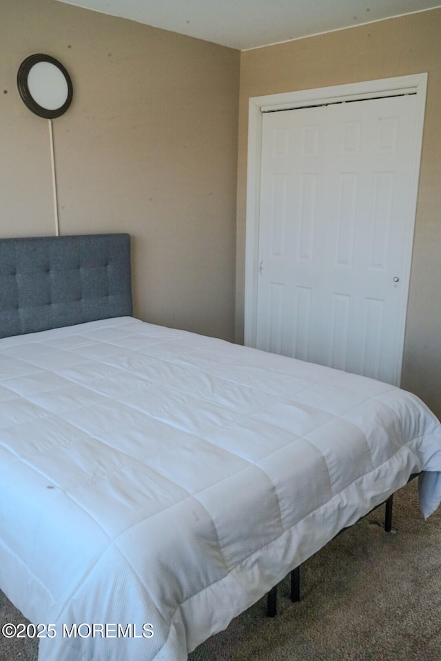 bedroom featuring a closet and carpet flooring