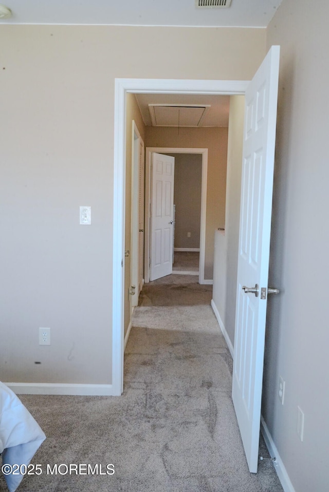 hall with light colored carpet