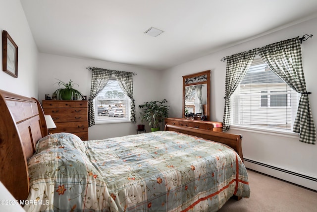 carpeted bedroom with a baseboard heating unit