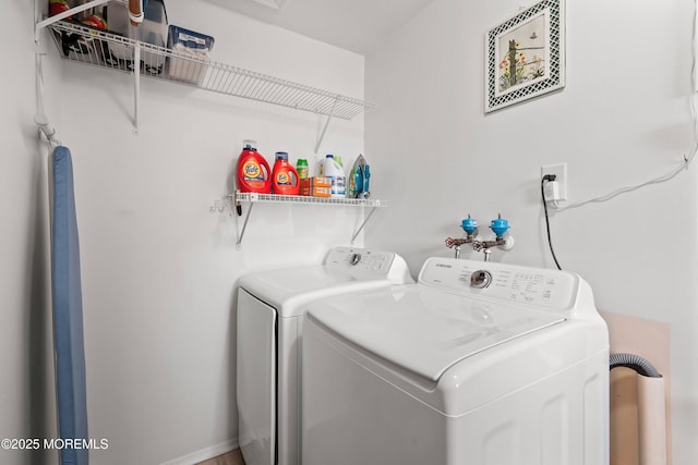 washroom featuring laundry area, washer and clothes dryer, and baseboards